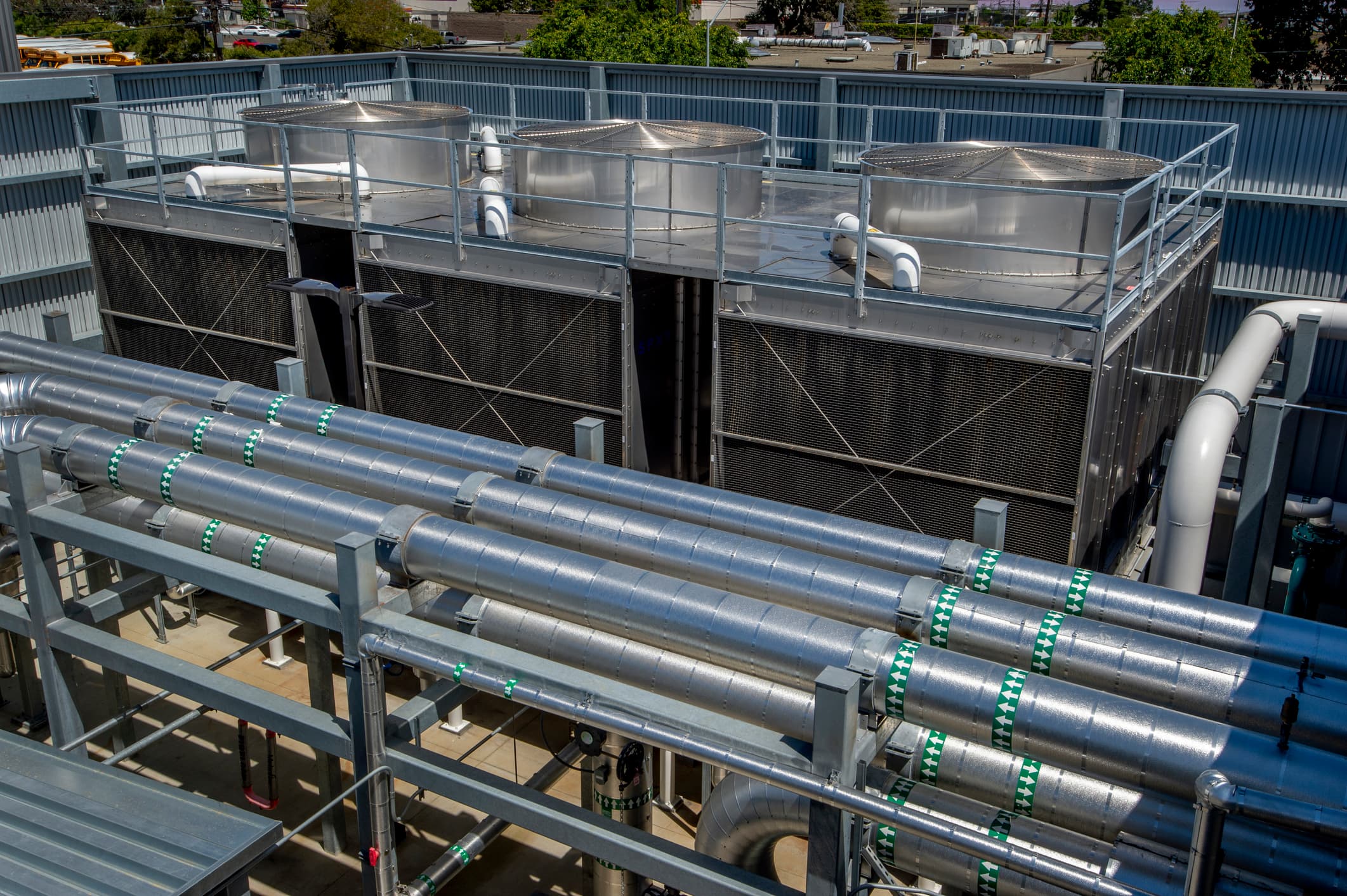 Rooftop cooling towers with insulated metal-jacketed process piping