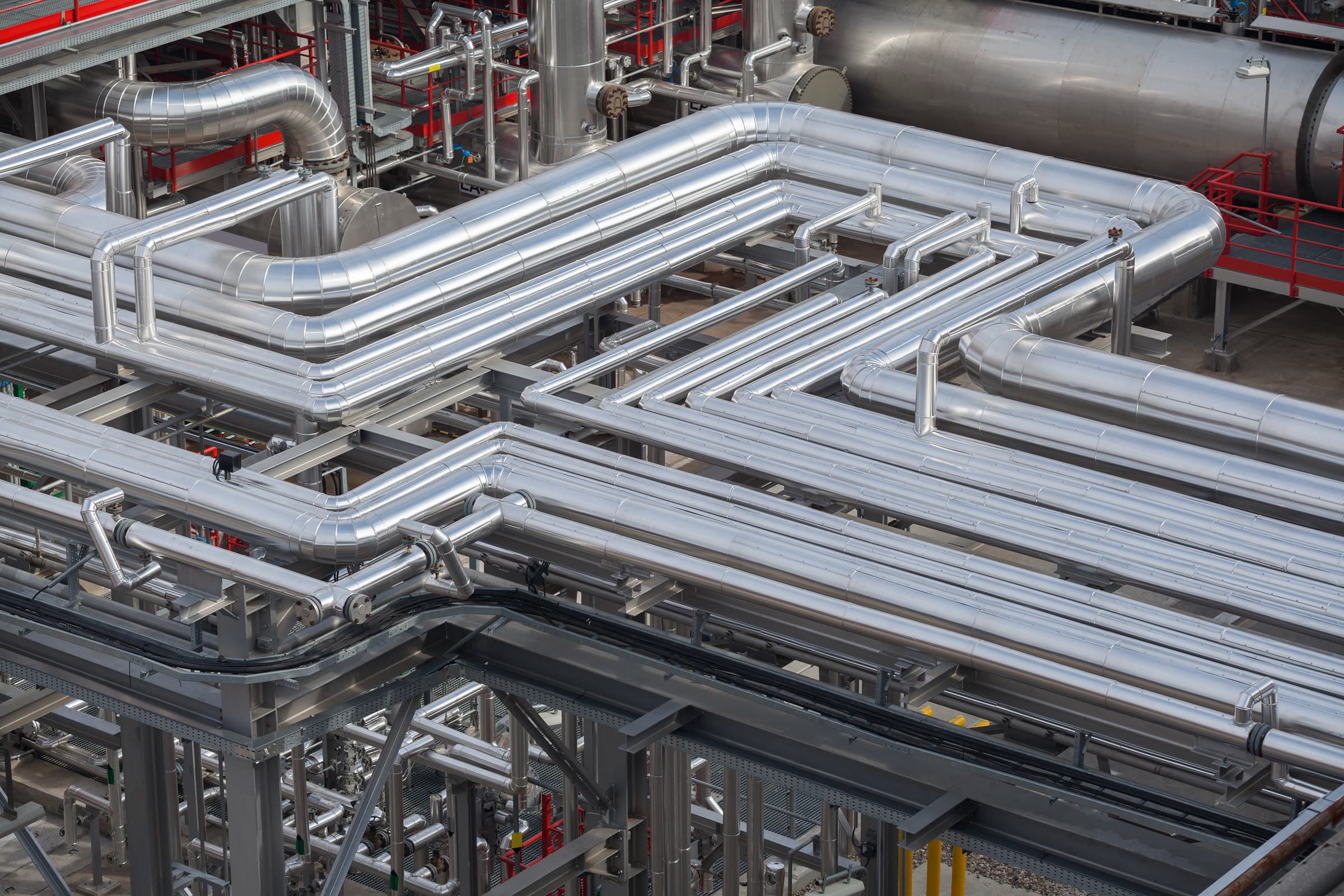 Insulated industrial process piping in a mechanical facility